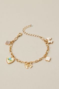 This charm bracelet features a dainty floral heart and bow pendant that will add a sweet touch of elegance to any outfit. Multi Charm Bracelet, Altered State Jewelry, Charm Friendship Bracelet, Dainty Charm Bracelet, Christmas Wishlist Ideas Aesthetic, Christmas Charm Bracelet, Charm Bracelet Ideas, Cute Charm Bracelets, Charm Bracelet Aesthetic