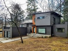 a modern house in the woods surrounded by trees