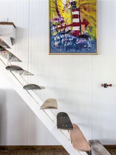 there is a painting on the wall and some skateboards are in front of it