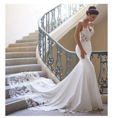 a woman in a wedding dress standing on some stairs