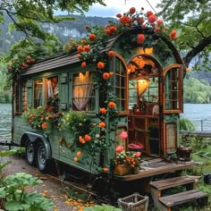 an old trailer converted into a house with flowers growing on it