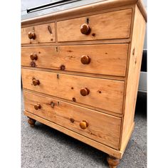 an old wooden dresser with knobs on it