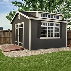 a small shed sitting on top of a lush green field