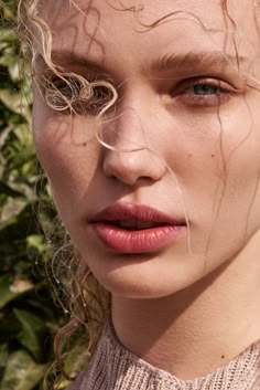 a close up of a woman with curly hair