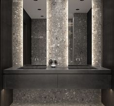 a bathroom with two sinks and mirrors on the wall next to each other in front of three lights