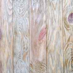 an image of wood planks that are painted white and brown with purple streaks on them