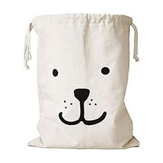 a white bag with a black dog face on the front and bottom, it has a draws