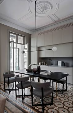 a dining room table with four chairs around it