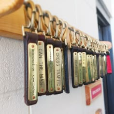 a row of key chains hanging from the side of a wall