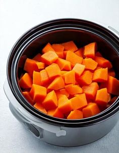 a bowl filled with cut up carrots on top of a table