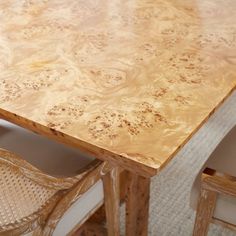 a wooden table with two chairs around it