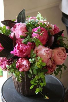 a bouquet of pink flowers sitting on top of a black table