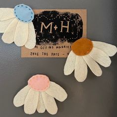 two white and pink flowers are next to a sign that says m + h, we got time market save the date