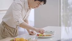 a man standing over a plate of food