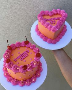 two heart shaped cakes sitting on top of plates with the words happy birthday written on them