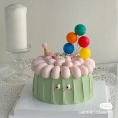 there is a cake with balloons on it