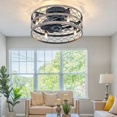 a living room filled with furniture and a ceiling fan