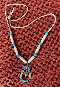 Native beaded hoop with arrowhead in the middle on a bone and bead necklace. This necklace is simple, yet beautiful and very unique. Native Necklace, Beaded Necklace Patterns, Bone Necklace, Hoop Design, Necklace Patterns, Native Style, Seed Bead Necklace, Jewelry Inspo, Bead Necklace