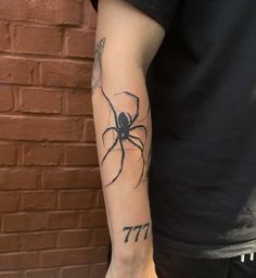 a man with a spider tattoo on his arm