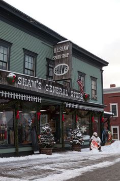 a store front with snow on the ground