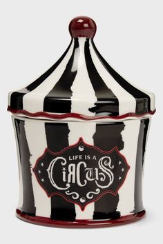 a black and white striped container with a red lid that says life is a circus