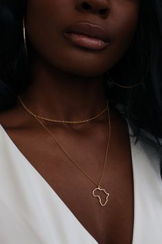 Africa, the inspiration for our brand, birthplace of humanity and civilization. How does one create jewelry to reflect it? The AFRICAN Potential Necklace Stack features the outline of the continent for you to fill with all your memories. Handcrafted with precious metals using the traditional lost-wax casting technique. Metal Info & CareAvailable in:Sterling Silver, 18K Gold Vermeil (18K Gold over Sterling Silver), Solid 10K, 14K, 18K, & 24K Gold. Made with fair trade African gold and con Necklace Black Women, African Gold, Africa Necklace, Necklace Stack, African Necklace, Map Necklace, African Jewelry, Girly Jewelry, Dainty Jewelry