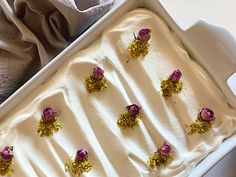 an ice cream dish with gold flakes and pink flowers