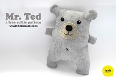 a gray teddy bear with black eyes is hanging on a white wall and has the words mr ted written below it