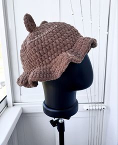 a crocheted hat sitting on top of a mannequin head