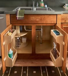 an open cabinet in the middle of a kitchen