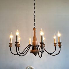 a chandelier with five candles hanging from it