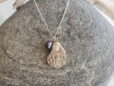 Small silver plated oyster shell pendant. The shell hangs from a sterling silver chain with a sterling silver clasp. Can be made with either a white pearl or a colorful peacock pearl. Shown here in 18 inch length. Also available in gold and found here:https://www.etsy.com/listing/460909492/small-shell-necklace-oyster-shell-pearl?ga_search_query=Oyster&ref=shop_items_search_2&frs=1&crt=1 *If you are unsure of the length you need, or would like to wear this item at different lengths, w Silver Shell Necklace With Pearl Pendant, Silver Shell Necklaces With Pearl Charm, Silver Shell-shaped Necklace With Pearl Pendant, Seashell Art Diy, Colorful Peacock, Peacock Pearl, Sea Jewelry, Seashell Jewelry, Nautical Jewelry