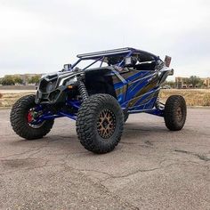 a blue and black four - wheeled vehicle parked in a parking lot with no wheels