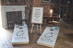 two cornhole game boards sitting on top of a wooden floor in front of a fireplace