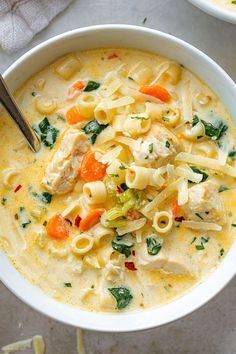 a white bowl filled with pasta and meat