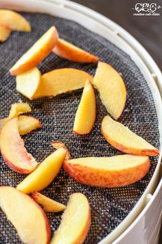 sliced apples are sitting in a white container