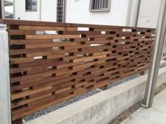 a fence made out of wooden planks on the side of a building