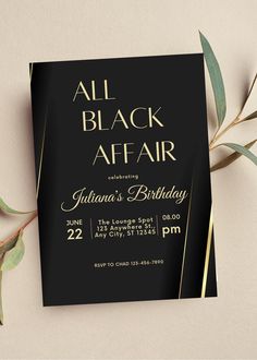 an all black affair birthday party with gold foil lettering and greenery on the table