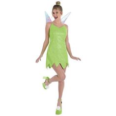 a woman dressed in a green tinkerbell costume and matching slippers is dancing