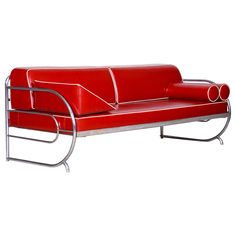 a red leather couch with chrome legs on a white background