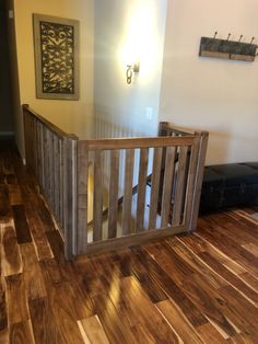 an empty room with hard wood floors and wooden railings on either side of the door