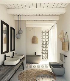 a bathroom with white walls and wooden floors