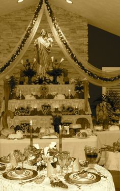 an image of a table setting with plates and silverware on it in front of a statue