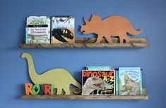 two bookshelves with wooden dinosaurs and children's bookends on them