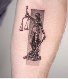 a lady justice tattoo on the arm