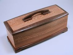 a wooden box sitting on top of a white table