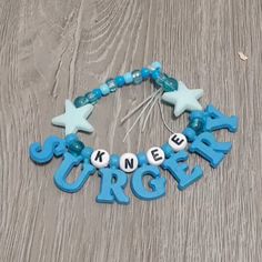 a blue bracelet with letters and stars that spell out the word crochet on it