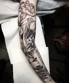 a person with a flower tattoo on their arm