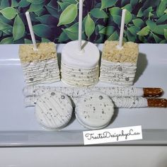 there are four cakes with candles on top of each one and some cookies in the middle