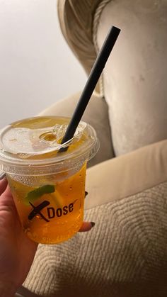 a person holding a drink with a straw in it